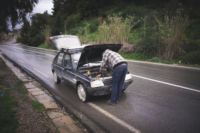 Mechanik samochodowy pracujący przy silniku w dobrze oświetlonym warsztacie